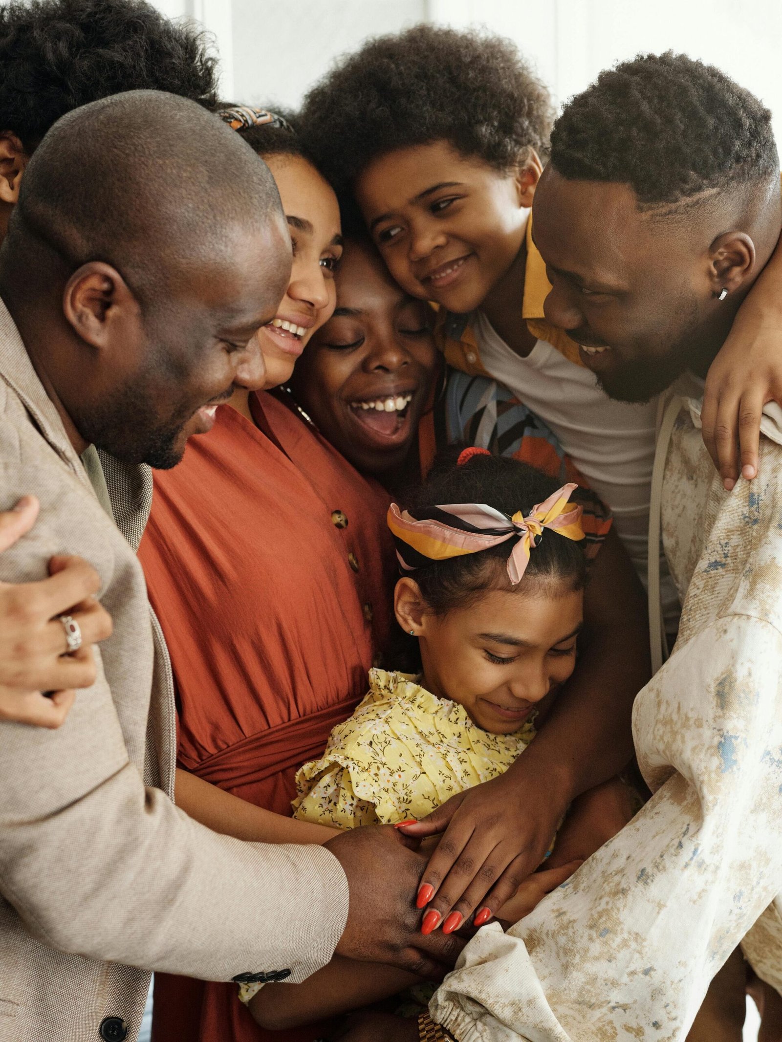 Heartwarming family group hug showcasing affection and togetherness indoors.